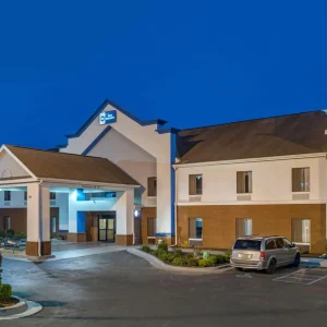 best western signage on building with cars