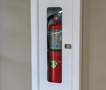 brown wall with white wall mounted fire extinguisher cabinet